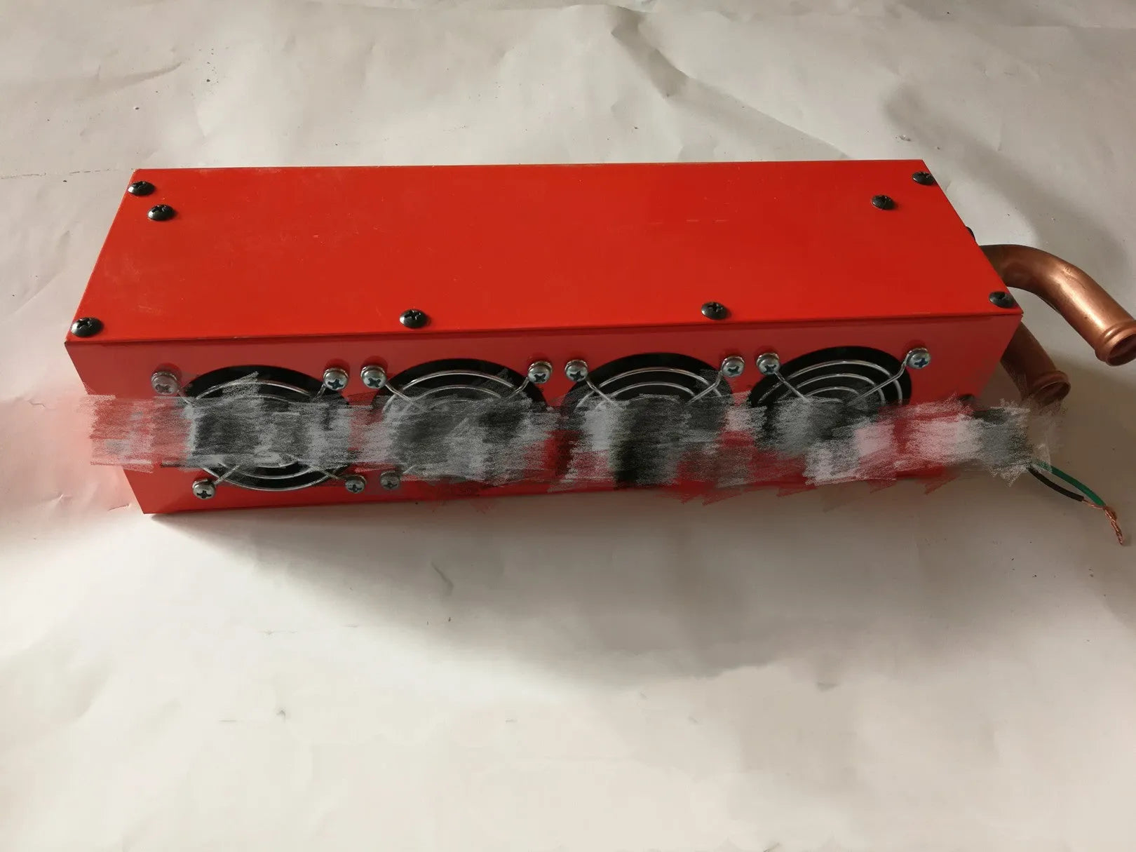 Compact metal 12V 24V car heater with four copper pipes and manual control, dimensions 34cm by 12cm by 8cm.