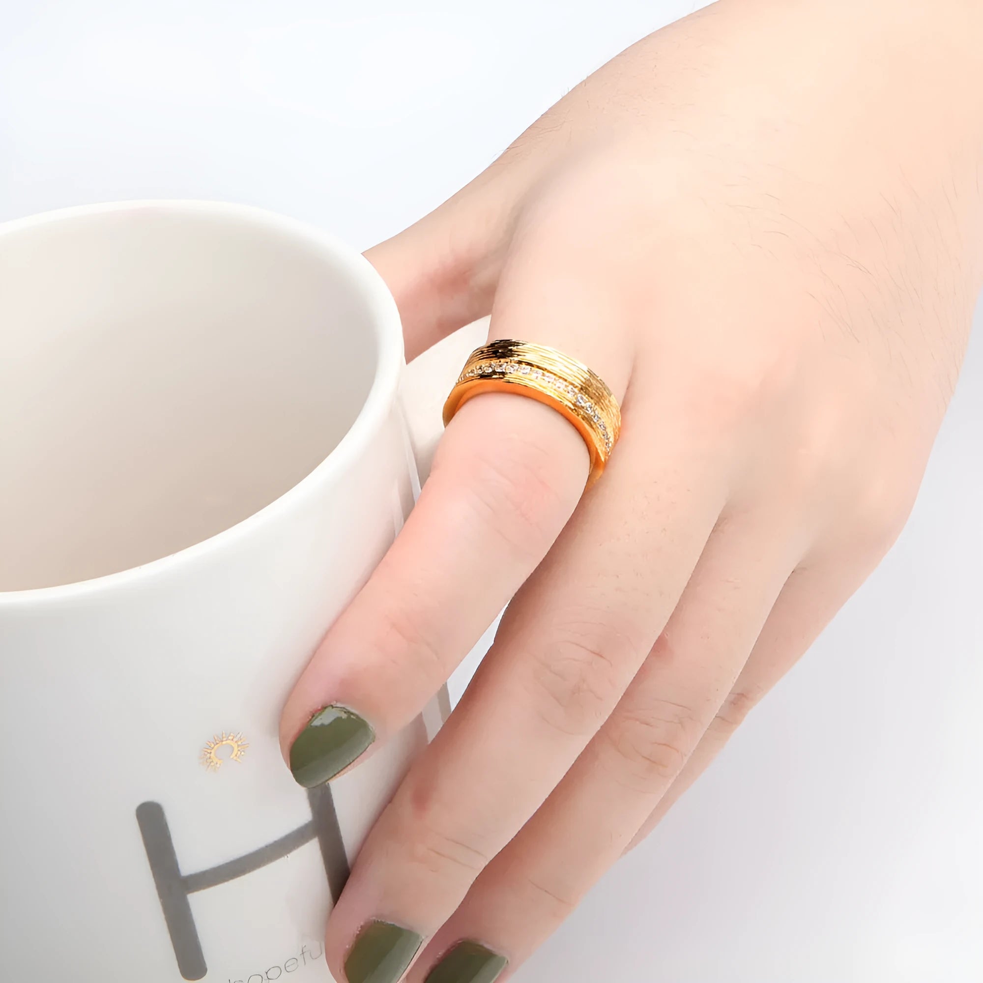 Gold geometric zircon ring for women on a white background.