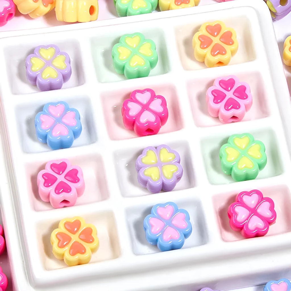 Acrylic clover craft beads with frosted finish in mixed colours including pink, blue and green