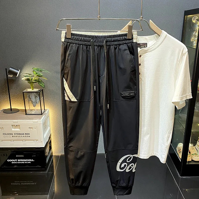 Black men's cropped casual trousers with an ankle band, made from thin Ice Silk cotton fabric.