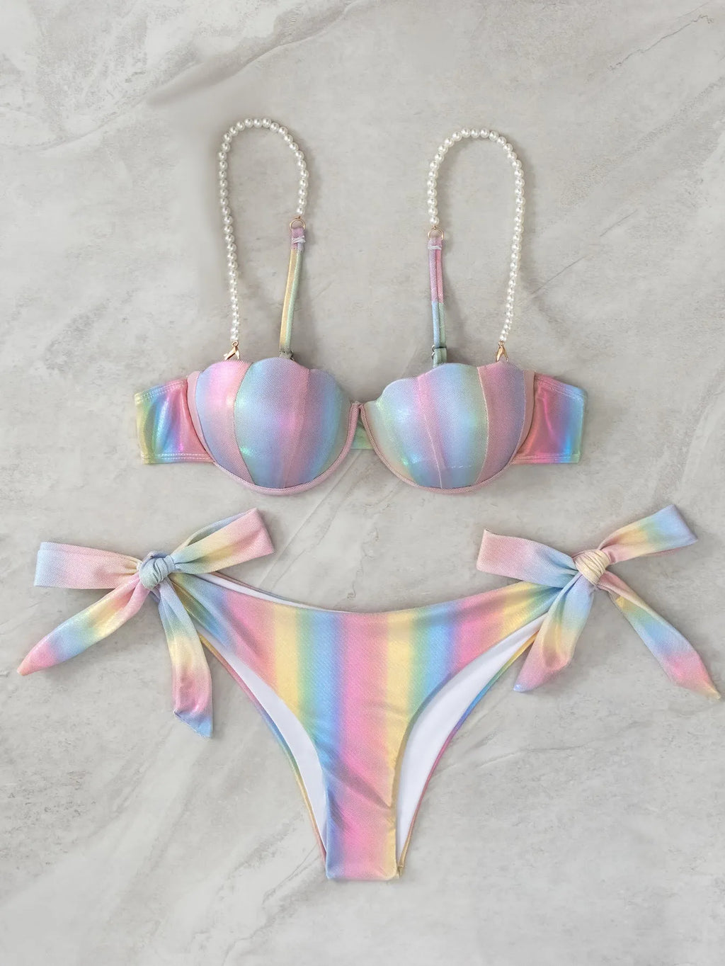 Women's shell rainbow print bikini swimsuit with split tied design on a beach background