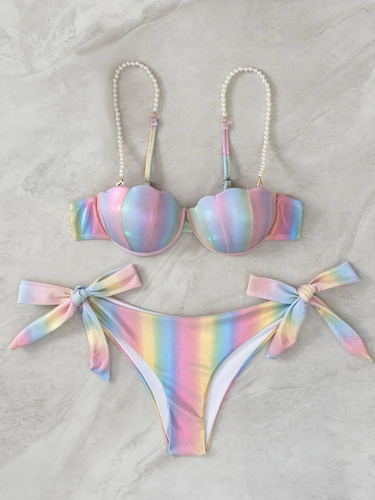 Women's shell rainbow print bikini swimsuit with split tied design on a beach background