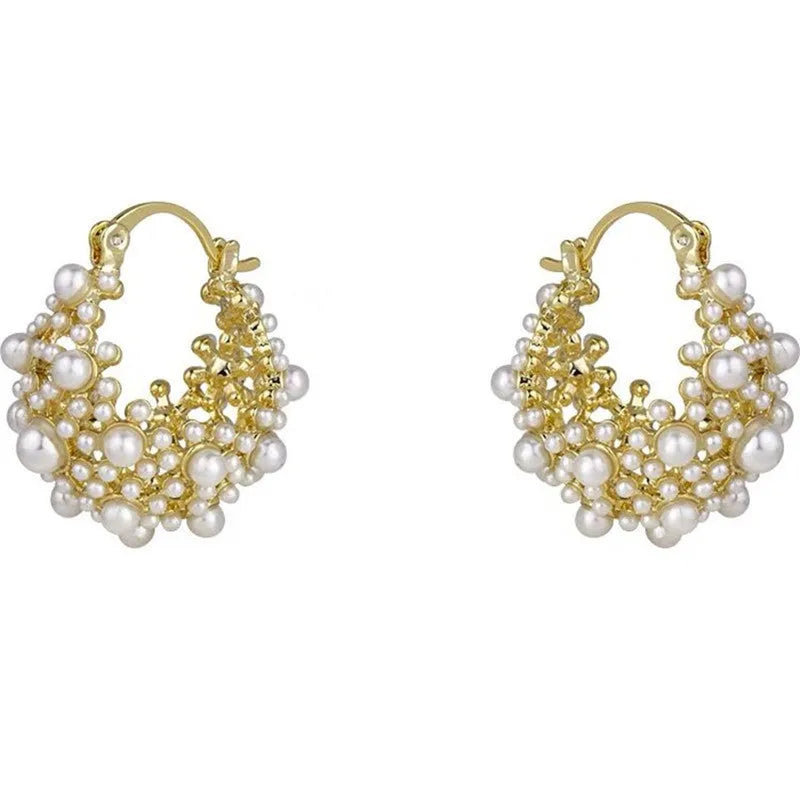 Gold women's copper earrings in a flower basket shape decorated with small rice-shaped beads.