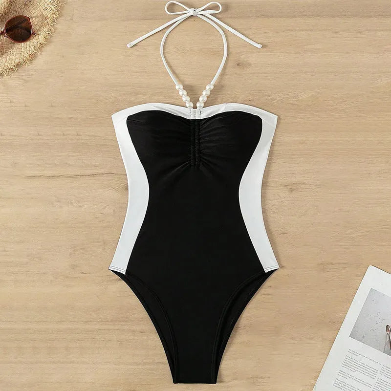 Black and white women's sleeveless one-piece swimsuit with slim fit and spaghetti straps