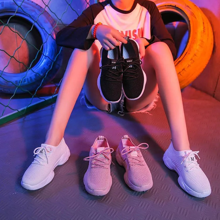 Women's white thick-soled sports shoes with woven mesh upper and front adjustable strap.