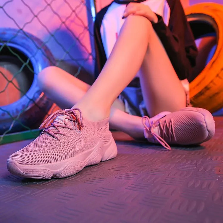 Women's white thick-soled sports shoes with woven mesh upper and front adjustable strap.