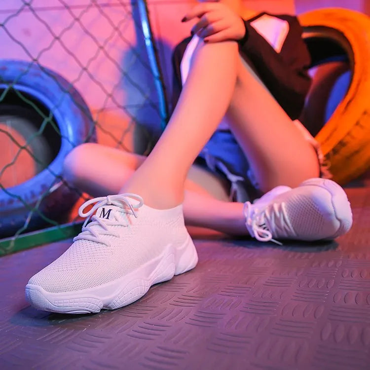 Women's white thick-soled sports shoes with woven mesh upper and front adjustable strap.