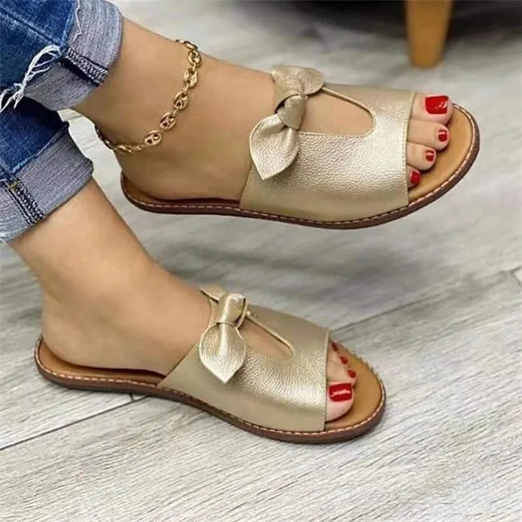 Ladies black sandals with bow detail and fish mouth open toe design on a white background