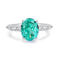 S925 silver emerald ring with high carbon diamond inlay in geometric ellipse shape on model finger.