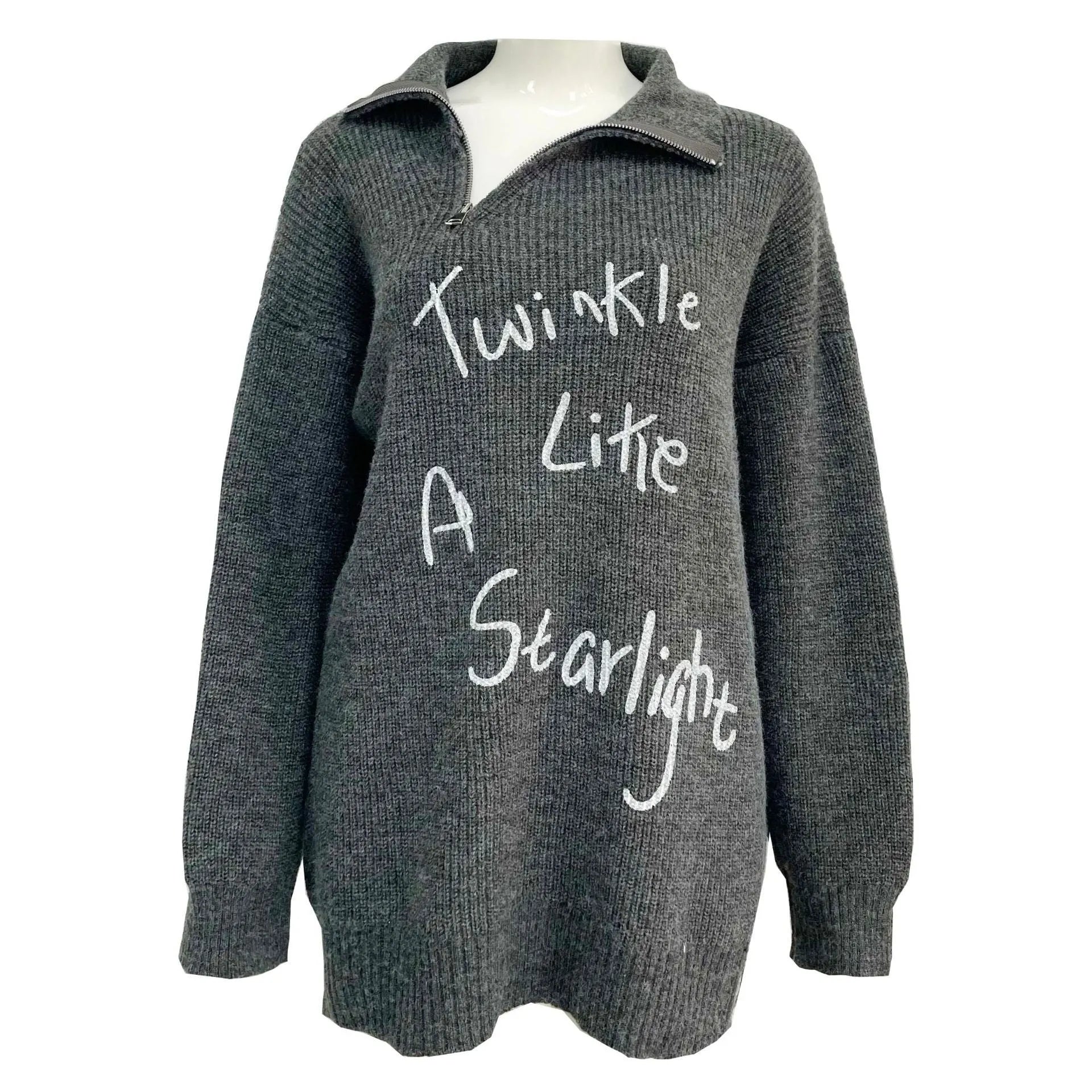 Woman wearing a light khaki retro pullover sweater with loose lapels, an oblique zip, and a text print.