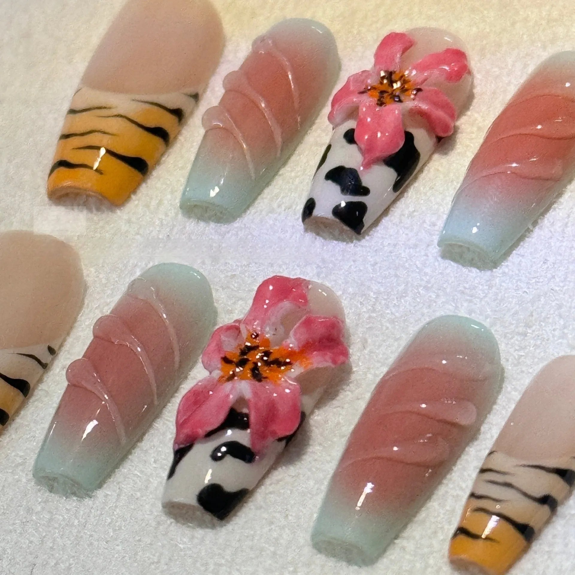 Zebra pattern lily hand carving nail art set showing embossed floral and leopard print designs