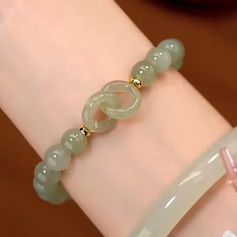 Chinese style handmade glass bead bracelet with bamboo joint elements on a white background.