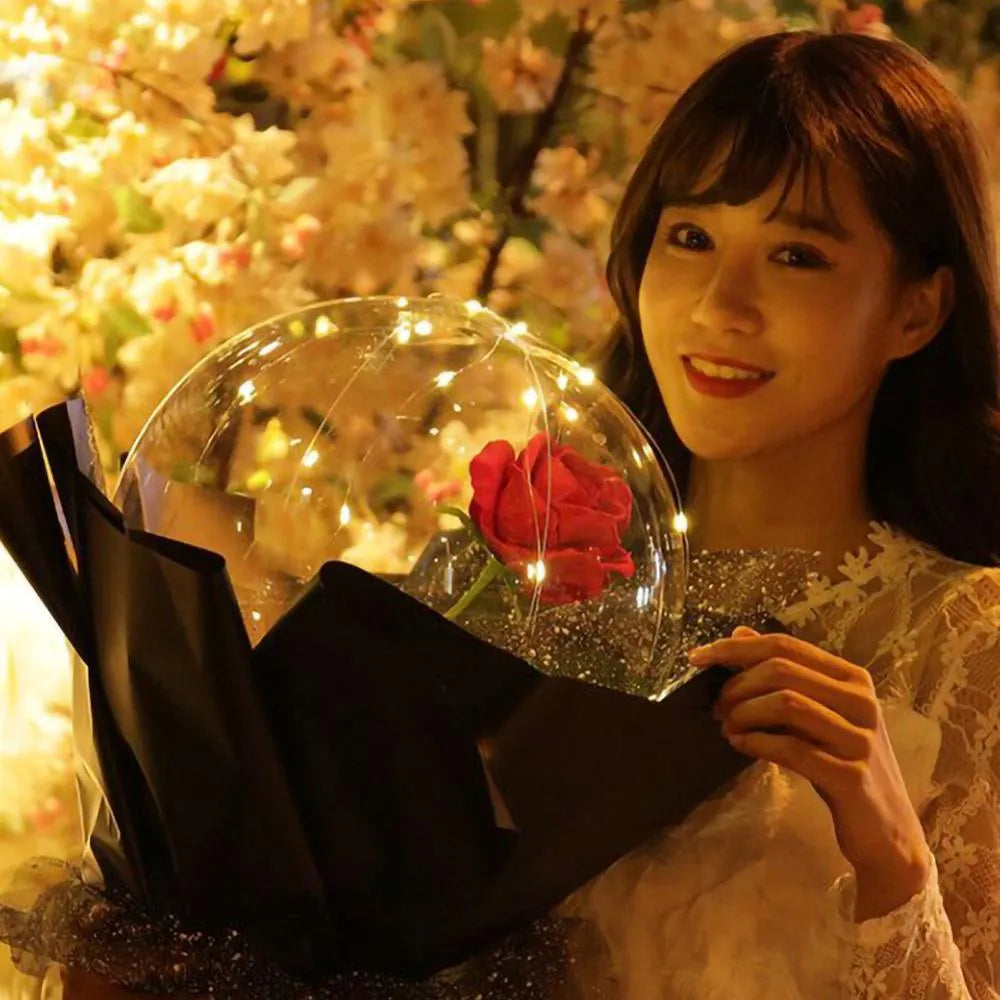 DIY LED luminous transparent balloon with artificial rose and lights inside for decoration.