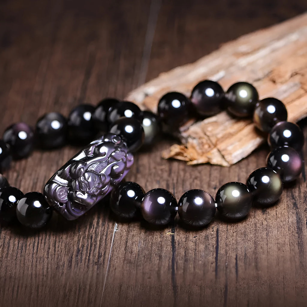 Polished crystal Pi Xiu bracelet on wrist, showing ethnic geometric style and Icy Obsidian colour.