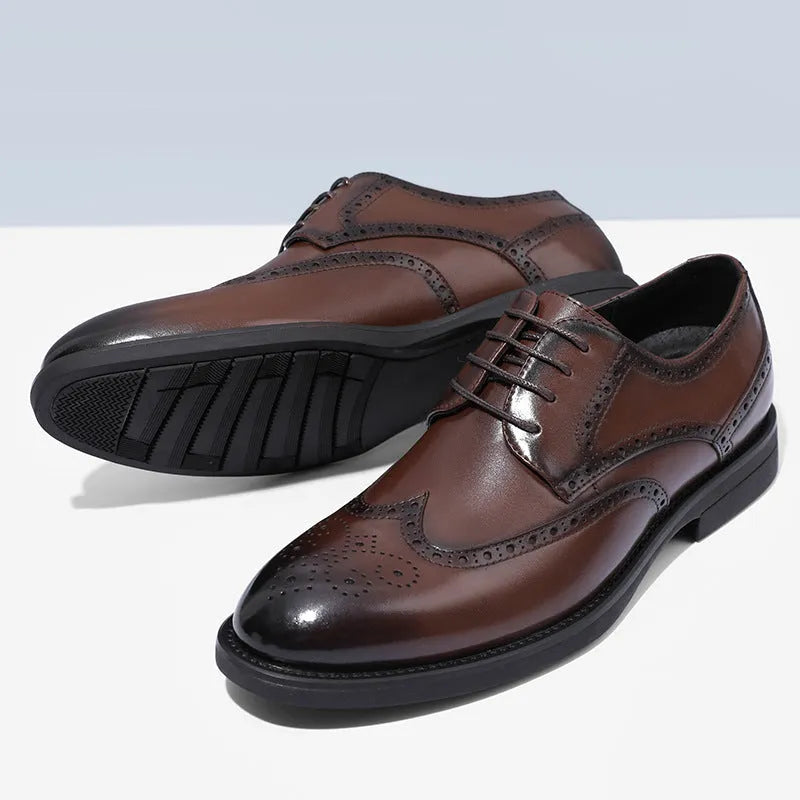 Men's black brogue leather shoes with decorative perforations and lace-up front.