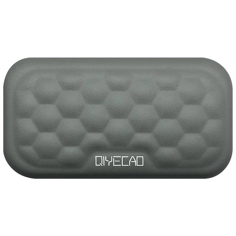 Grey and black memory cotton mouse wrist pads in cloth and leather styles on a desk.