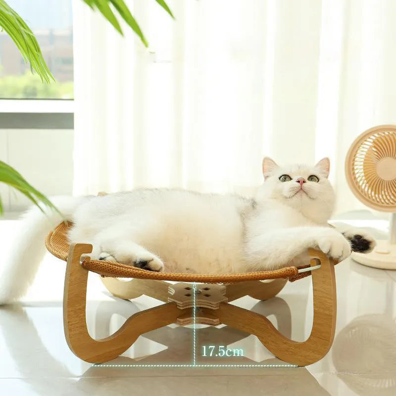 Brown woven rattan pet hammock bed for cats and small dogs on a white floor
