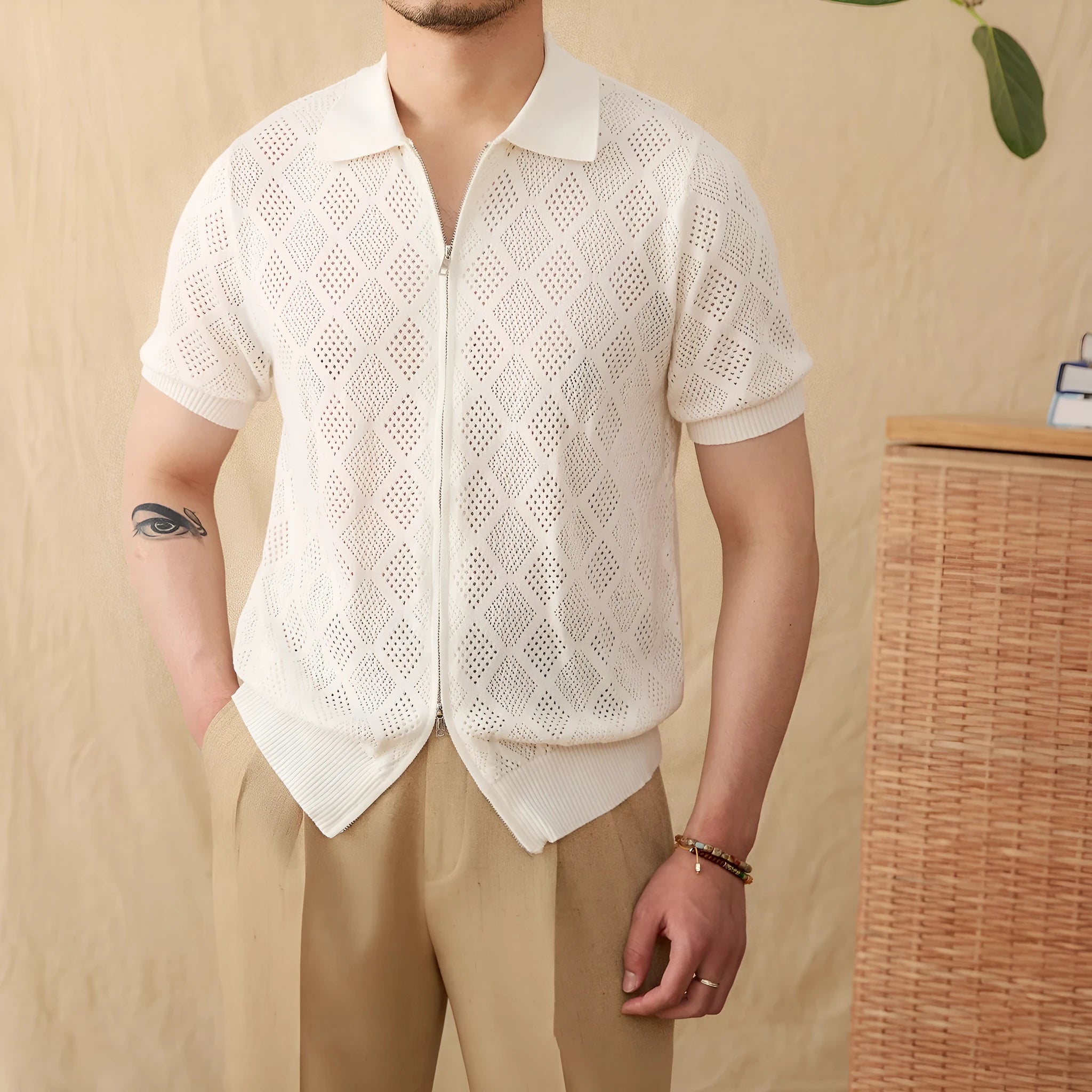 Light brown cotton short sleeve cardigan with zip front and lapel collar laid flat.