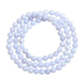 Close-up of a blue agate bracelet with multi-circle patterns, striped beads, and a Ruyi element on a neutral background.