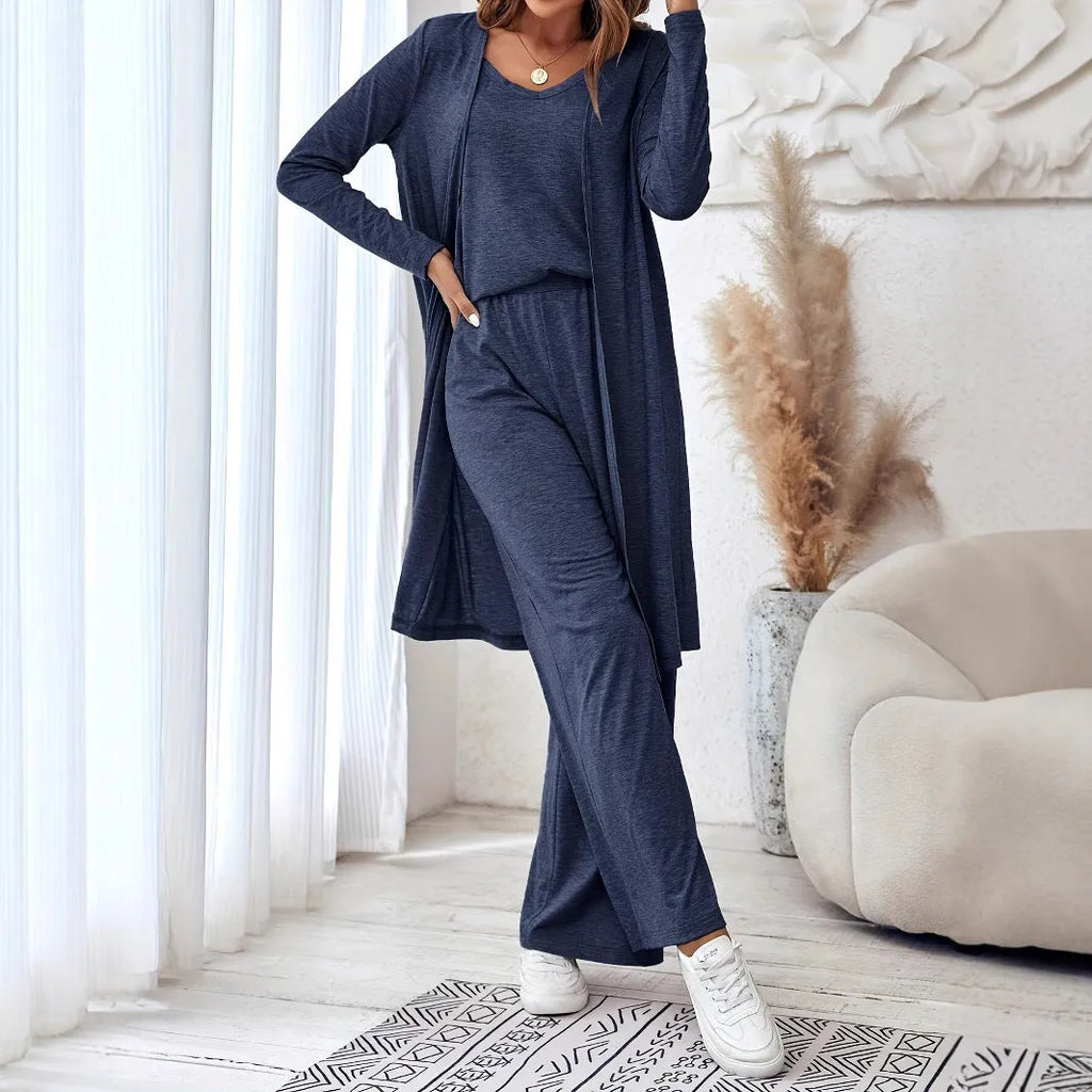 Blue women's three-piece casual suit set with sling top, long cardigan, and trousers on a hanger.