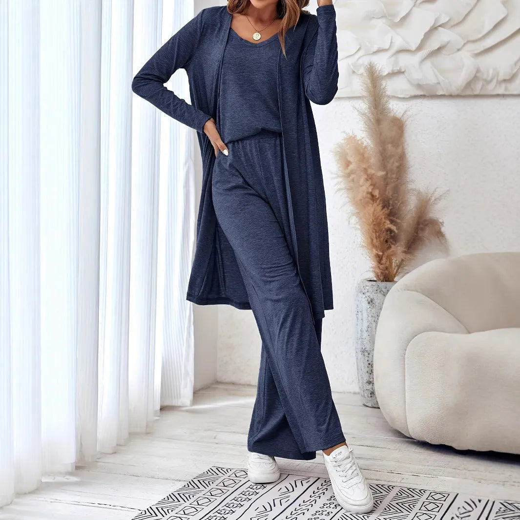 Blue women's three-piece casual suit set with sling top, long cardigan, and trousers on a hanger.