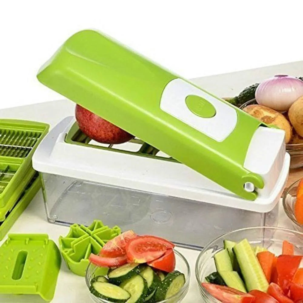 Green manual food chopper with multiple stainless steel accessories on a kitchen counter.