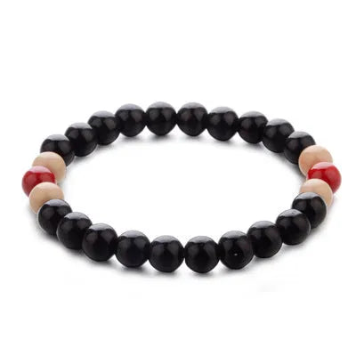 Unisex natural stone bead bracelet with lava stones for essential oils, ethnic style, on a wrist.