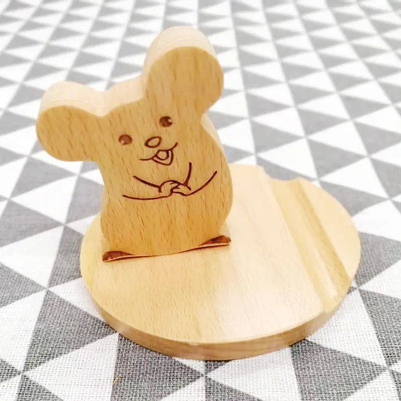 Beech wood mobile phone holder with resin animal decoration and custom lettering on coin back.