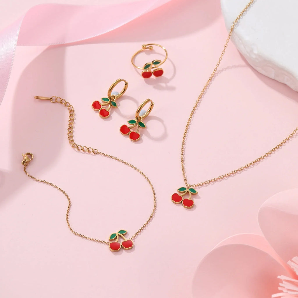 Cherry design stainless steel necklace, bracelet, earrings, and ring set with 18K electroplated finish.