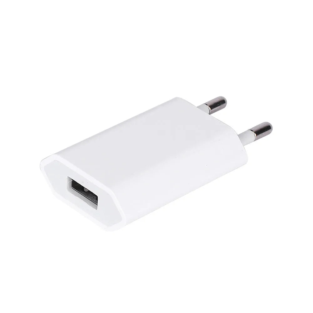 White 5V 2A USB travel charger and Lightning cable for iPhone and iPad on a wooden table.