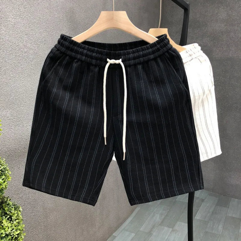 Men's black and white striped casual shorts with elastic waistband showing straight-leg design