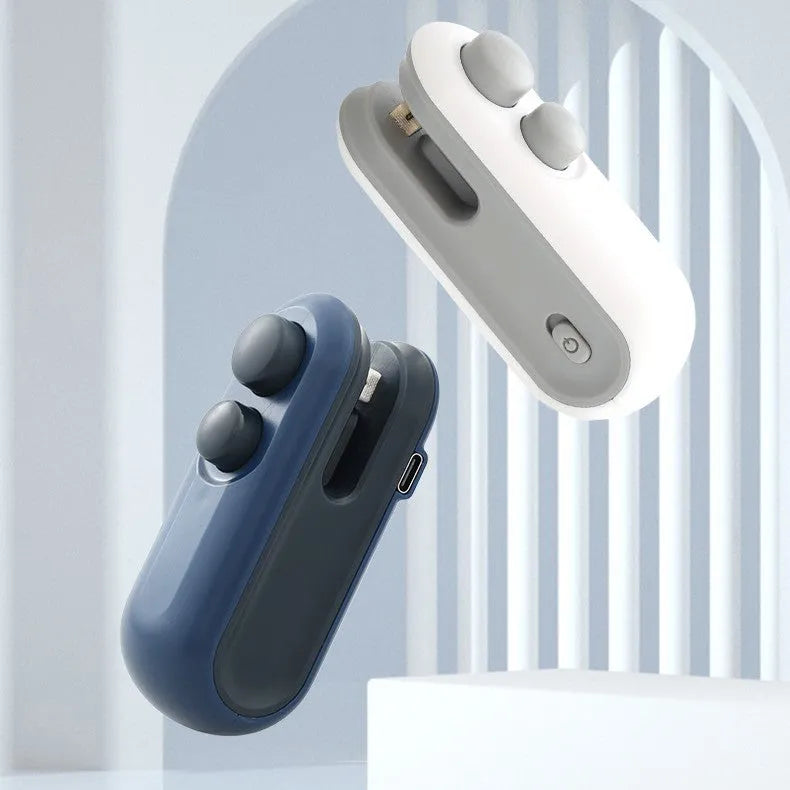 Blue handheld vacuum heat sealer with cutter blade and magnetic backing for food storage