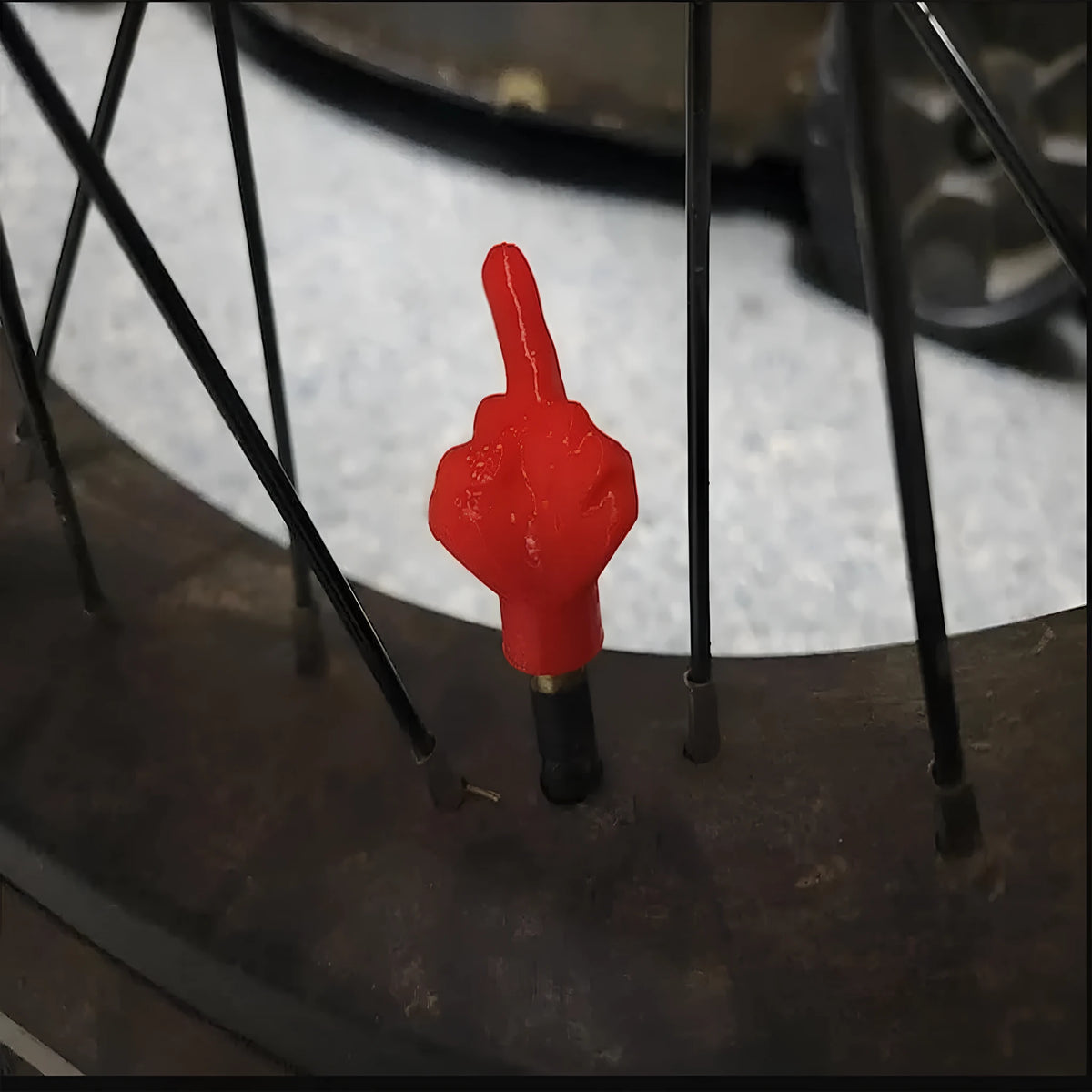 Four latex car tyre valve dust caps, two black and two skin colour, arranged together.