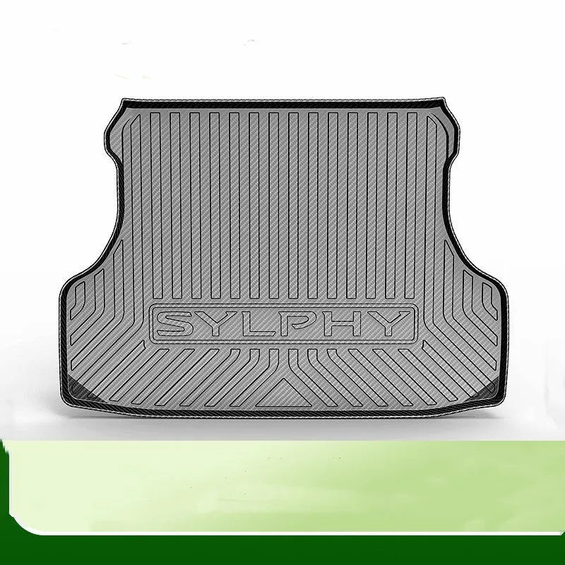 Black carbon fibre pattern TPE trunk pad installed in a car boot showing custom fit and textured surface
