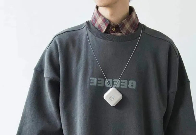 Mini USB air purifier necklace in blue, showing compact rectangular design on a lanyard.
