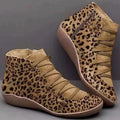 Women's black casual ankle boot with a flat wedge heel and round toe on a plain background.