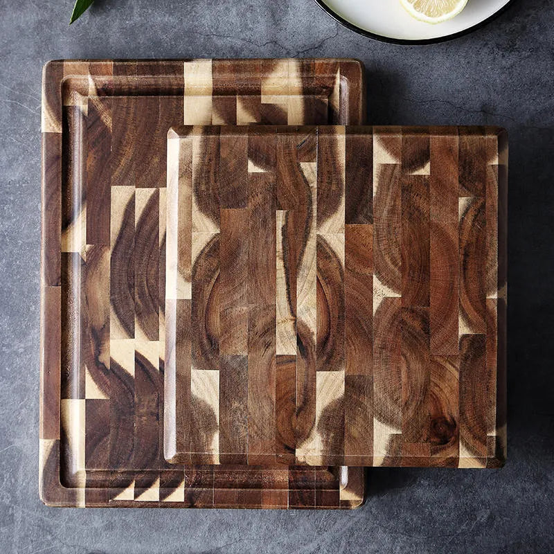Brown solid acacia wood cutting board with 3cm thickness on a kitchen counter.