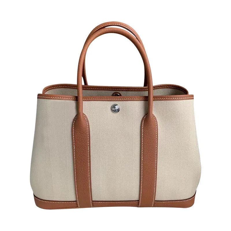 Women's canvas crossbody tote bag with leather detailing in bucket shape design