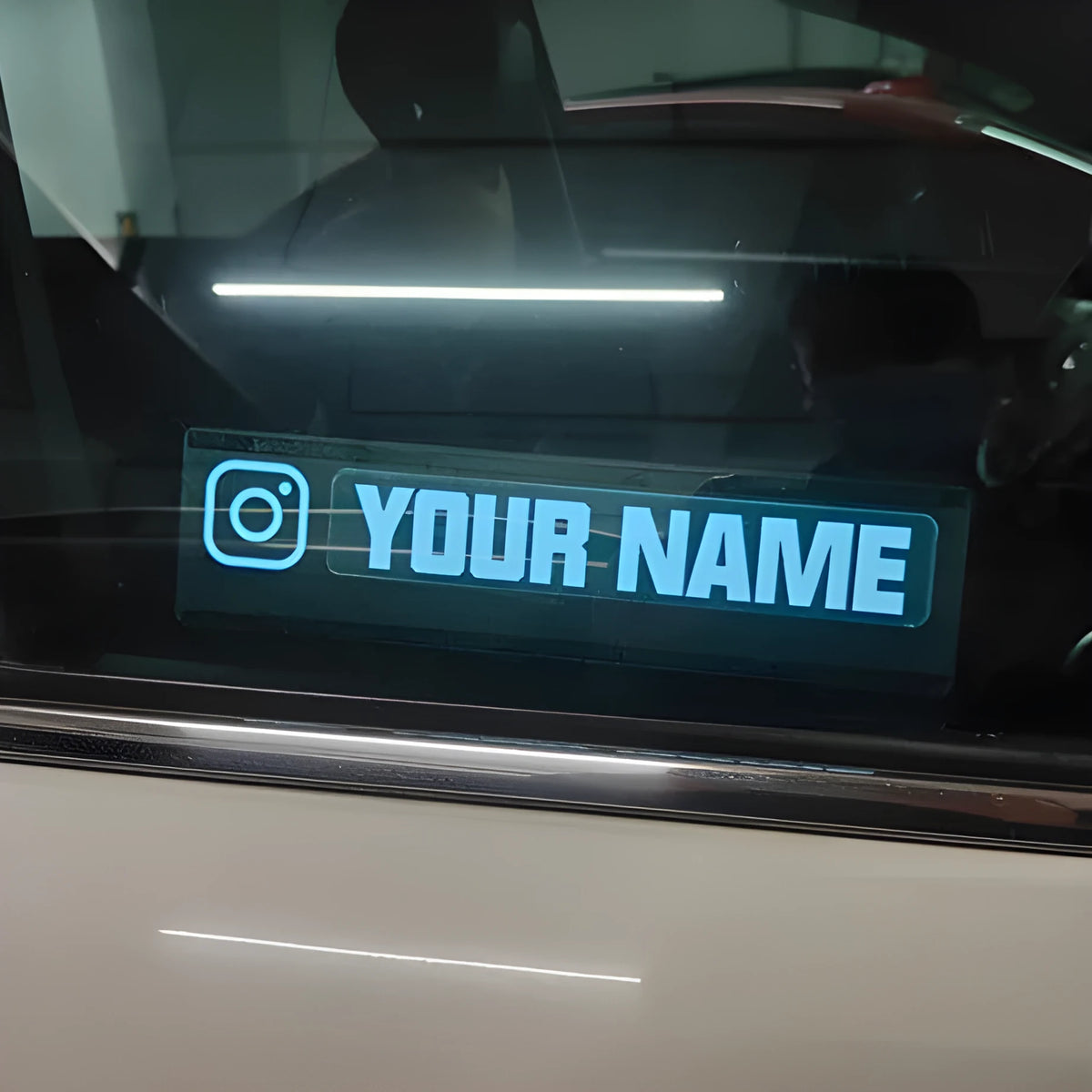 Electroluminescent car window sticker kit with driver and cable, showing foundation white glow.