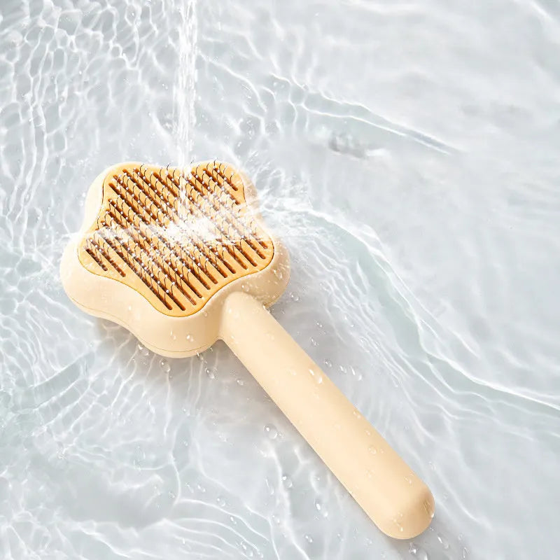 Green or yellow self-cleaning cat comb with stainless steel teeth, showing 20cm length.
