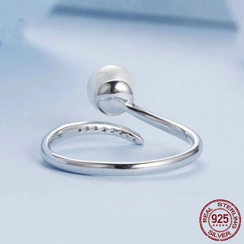 Adjustable open loop sterling silver ring with natural shell pearl in 8 US sizing