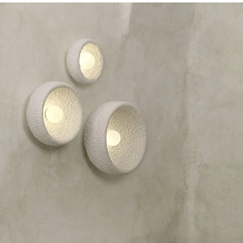 Japanese-style modern simple wall lamp with a round resin shade in warm white light.