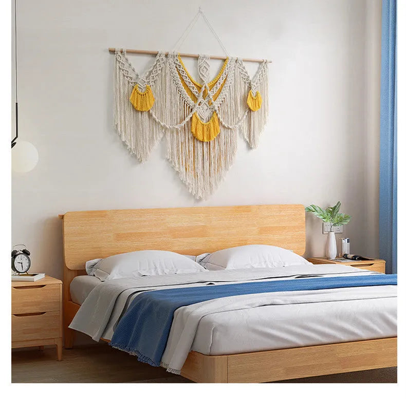 Creamy white hand-woven cotton Nordic tapestry hanging on a wall, 120cm wide by 95cm high.