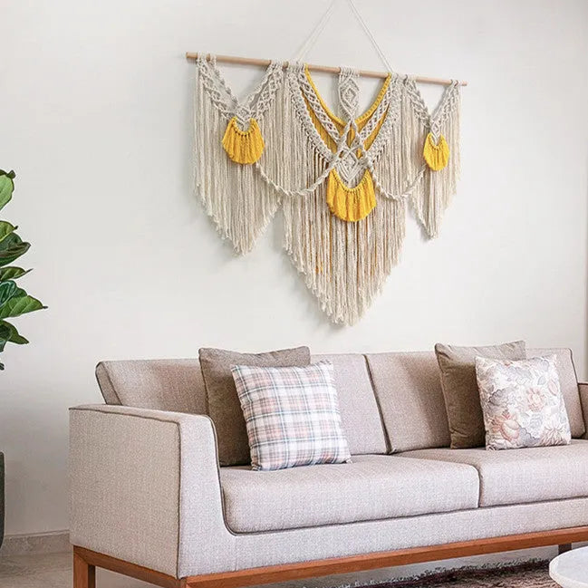 Creamy white hand-woven cotton Nordic tapestry hanging on a wall, 120cm wide by 95cm high.