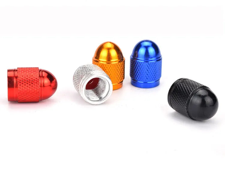 Set of aluminium alloy tyre valve caps for mountain bikes in black, blue, gold, silver, and red colours.