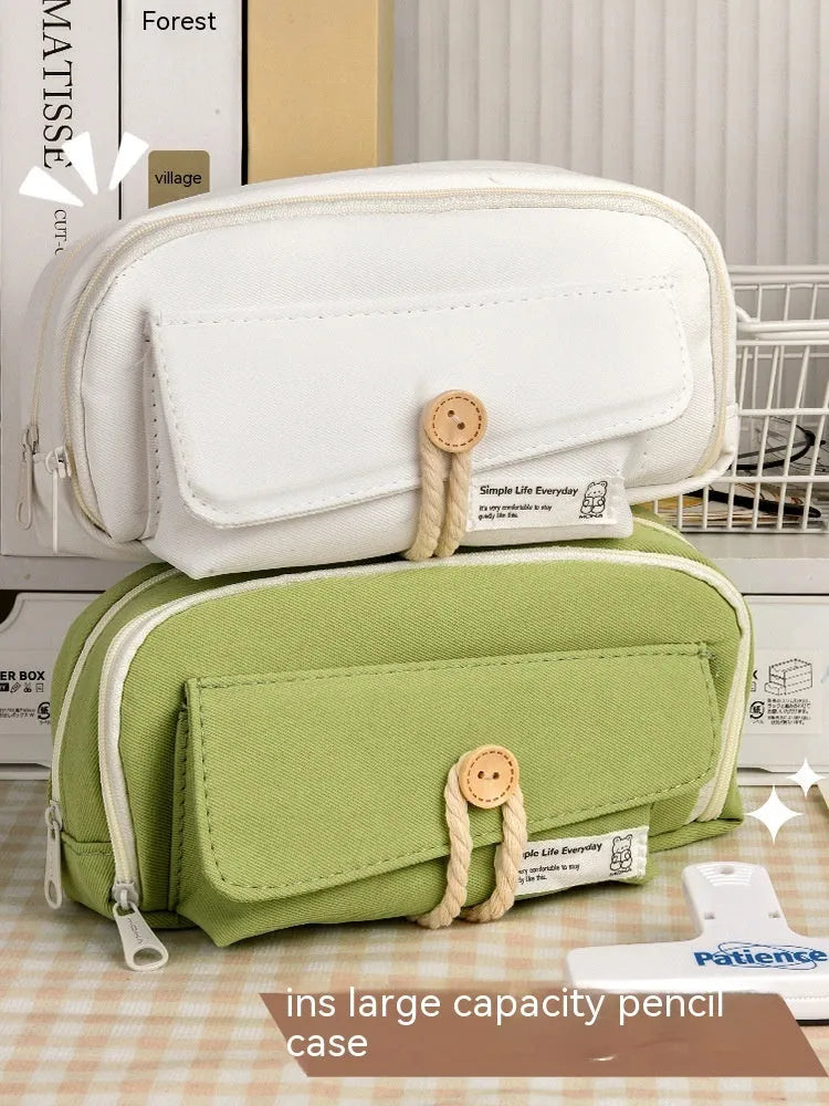 Korean style canvas pencil case in green, beige, blue, or grey, showing large capacity for pens.