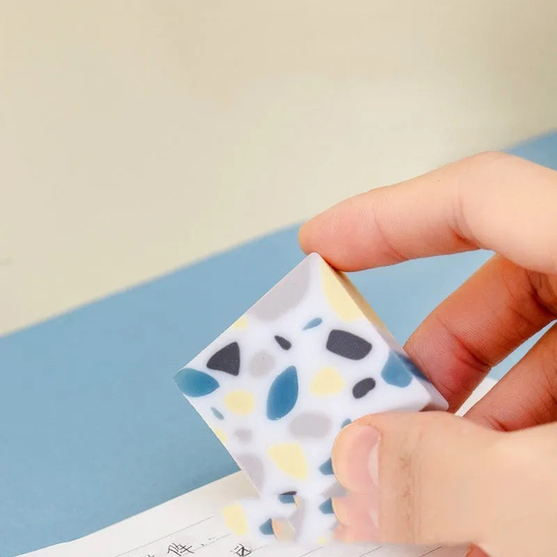 White rubber brick eraser for clean pencil mark removal.