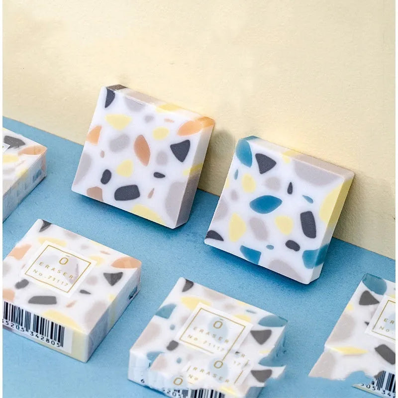 White rubber brick eraser for clean pencil mark removal.