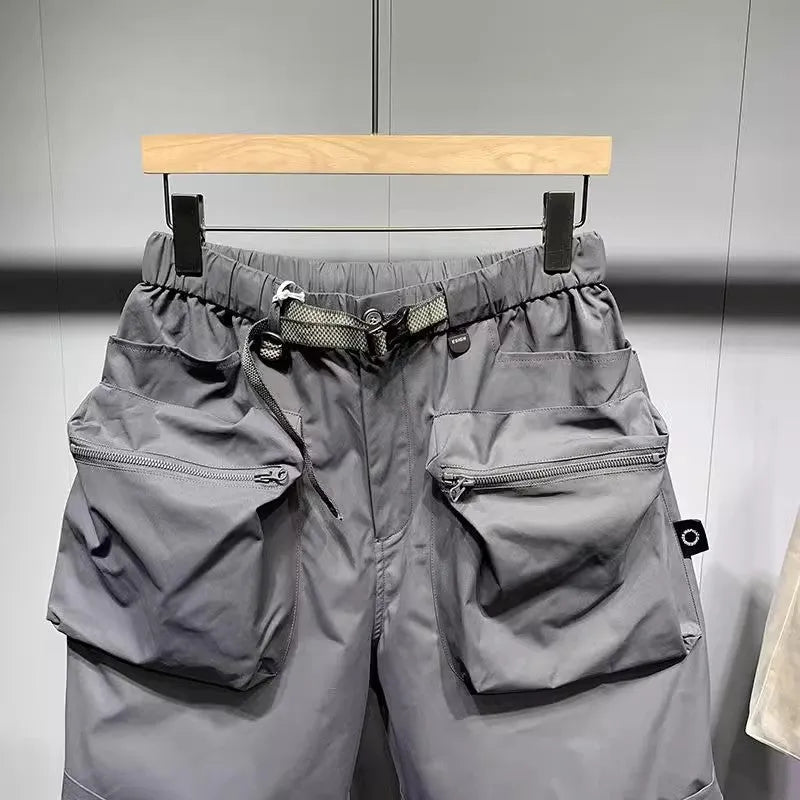 Men's black loose-fit workwear shorts with pockets in above-knee length