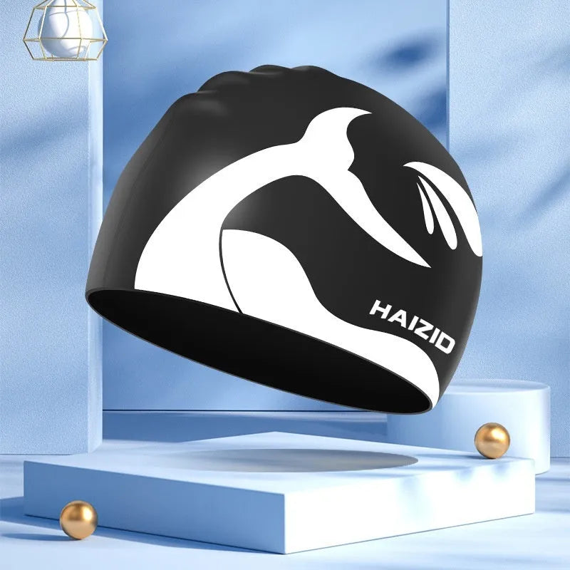 Silicone swimming cap with whale tail pattern and integrated ear protectors in grey.